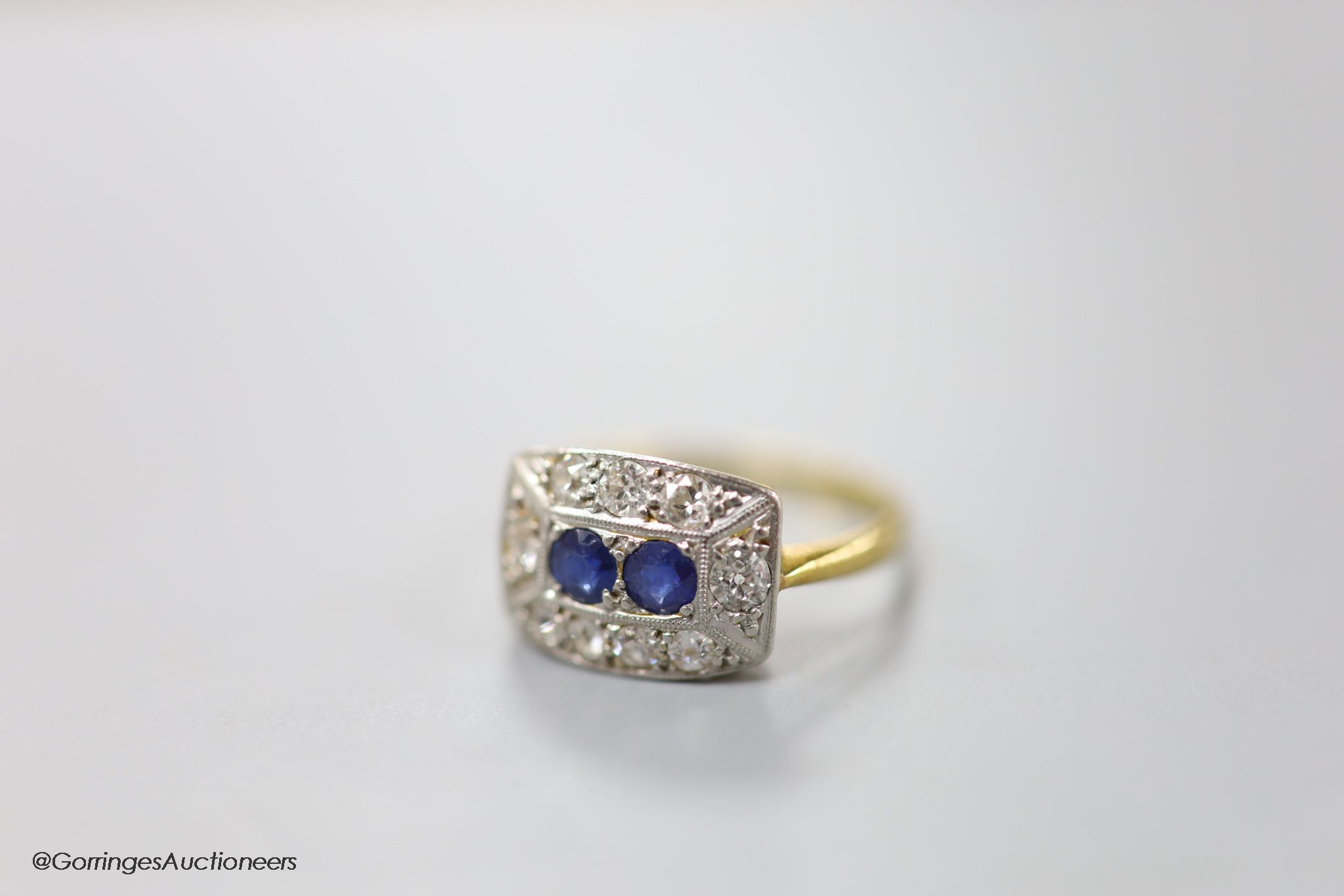 A 1930's/1940's 18ct & Pt, sapphire and diamond set shaped rectangular cluster ring, size M, gross weight 3 grams.